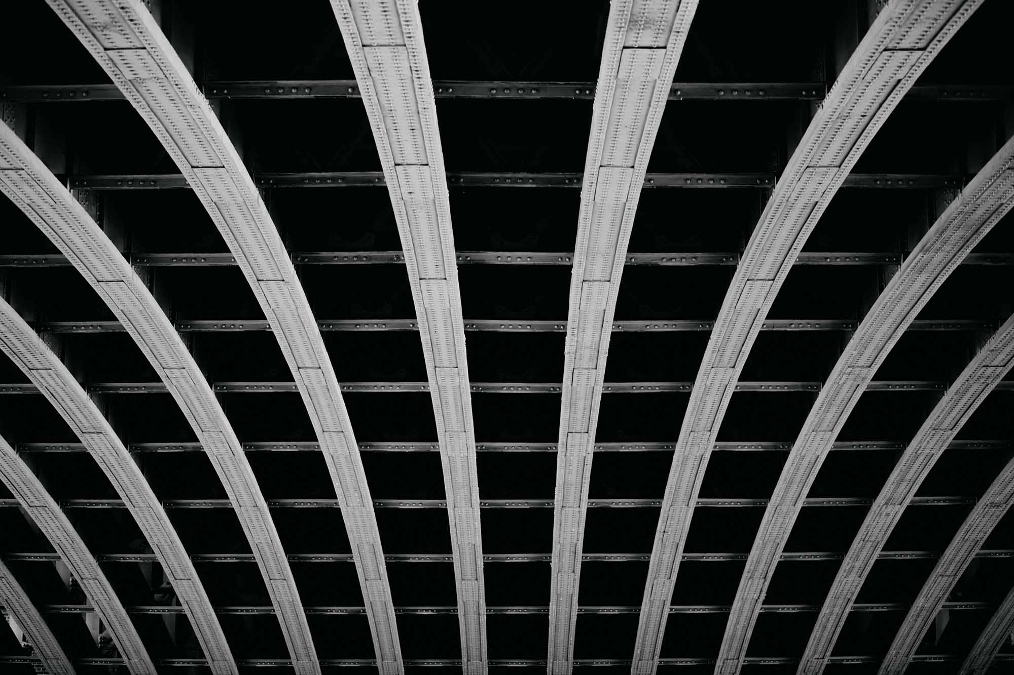 Architectural patterns of Southwark bridge in B&W.